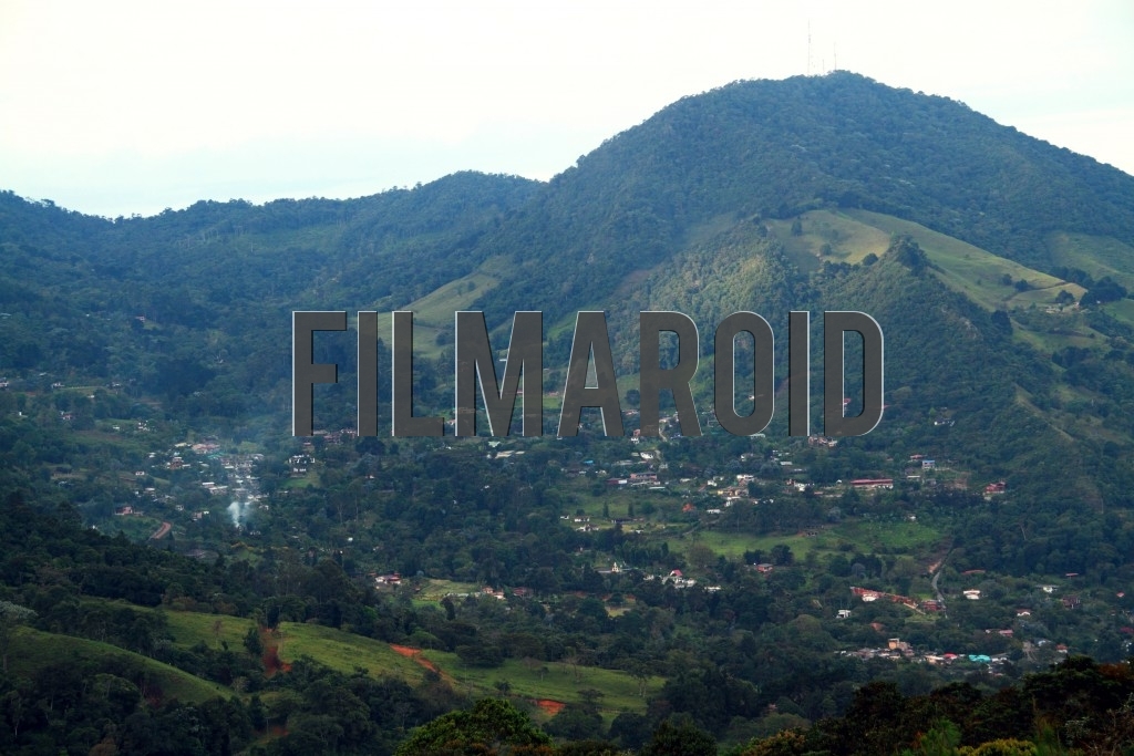 Impressive Mountain Peak seen from a distance and a village as part of the landscape