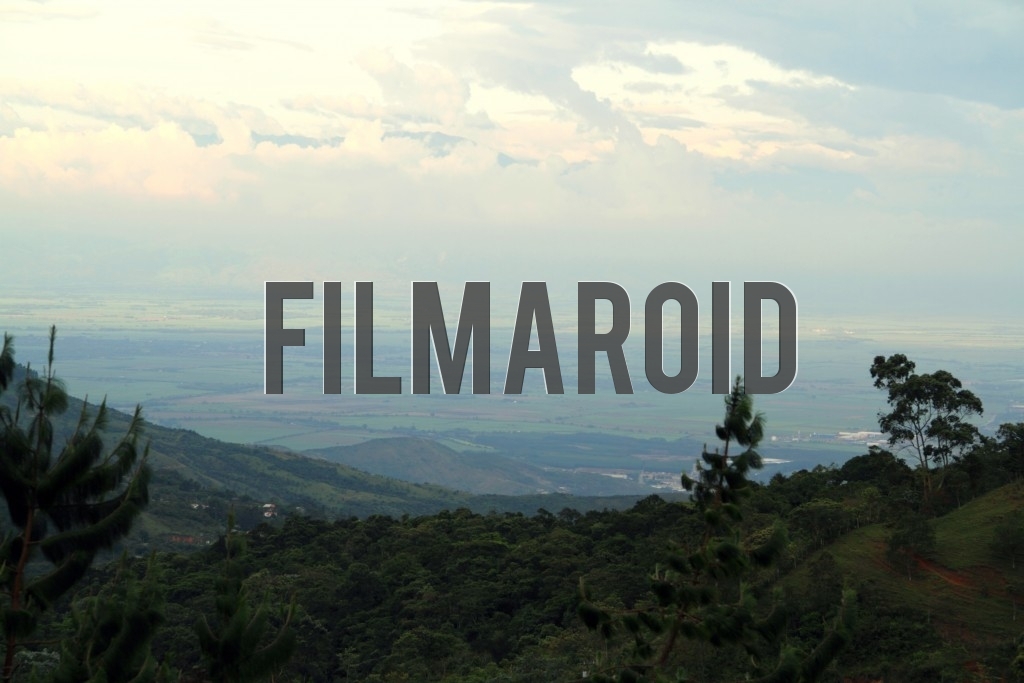 Landscape of the valley of Valle del Cauca Region with Andean Mountain Range in background and framed by mountains and trees
