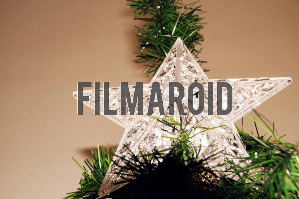 An acrylic Christmas tree star ornament decorated with fine details