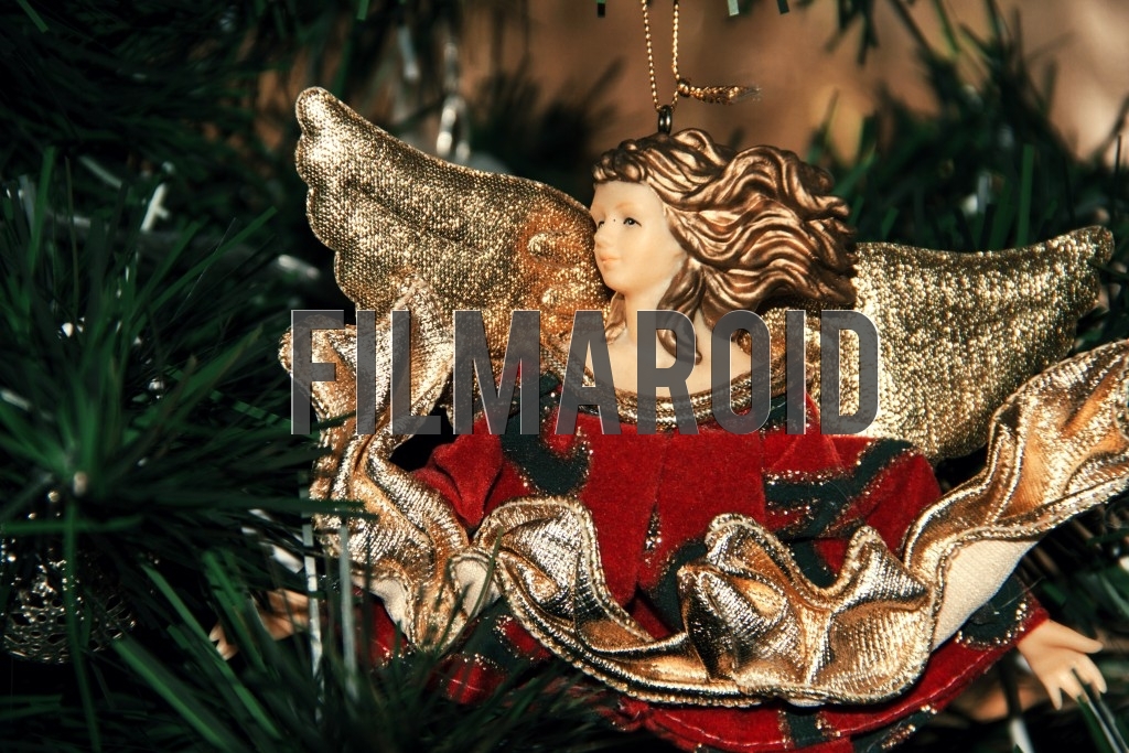 Red and gold Christmas tree angel ornament Red and gold Christmas tree angel ornament - A red Christmas tree ornament of an angel with golden wings