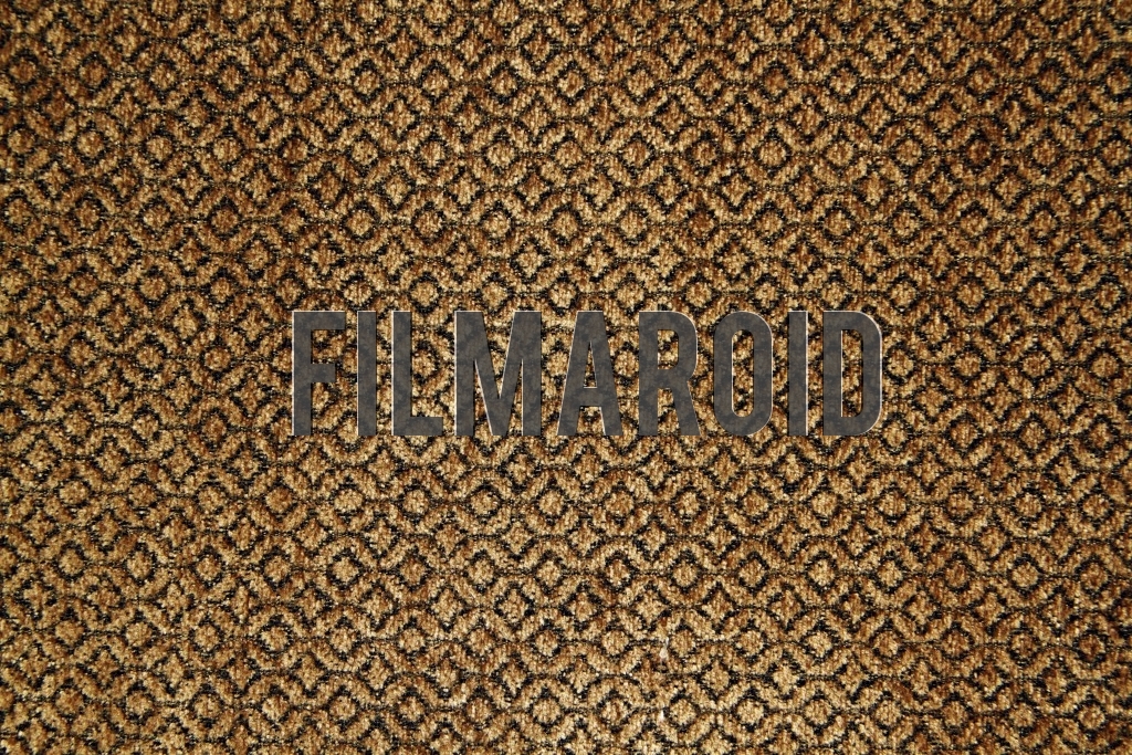 An old golden fabric for upholstery with diamond patterns and texture