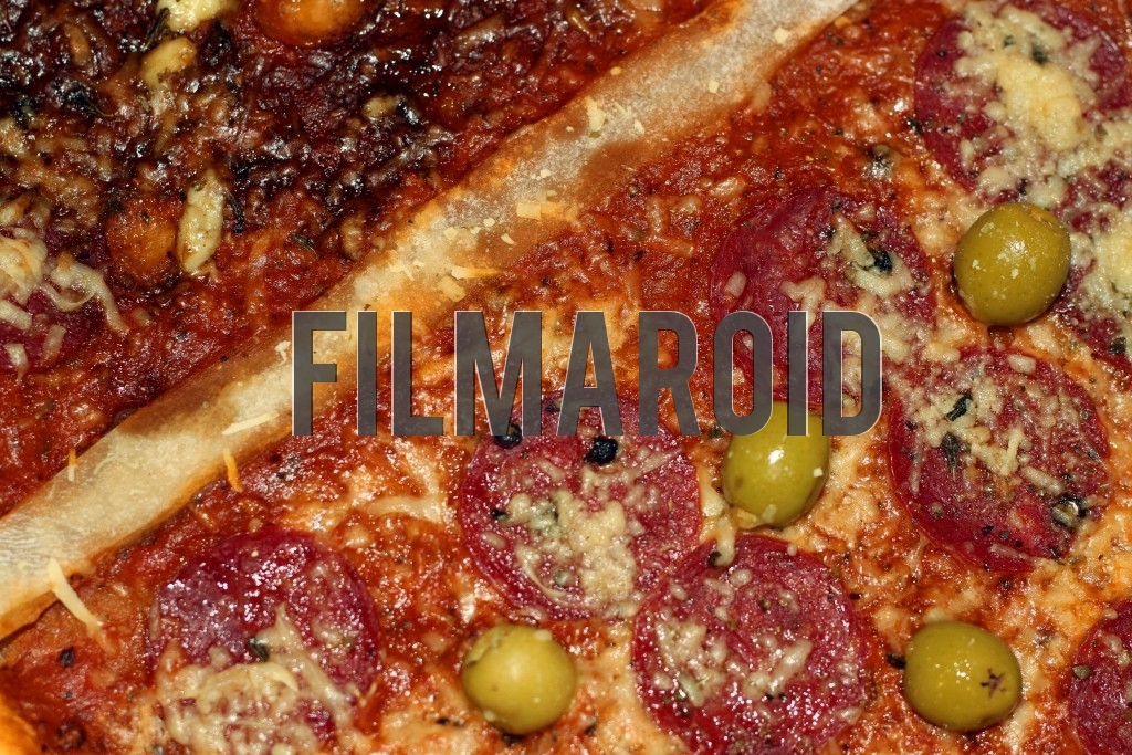 Texture view of pepperoni pizza with parmesan cheese some pepper and green olives