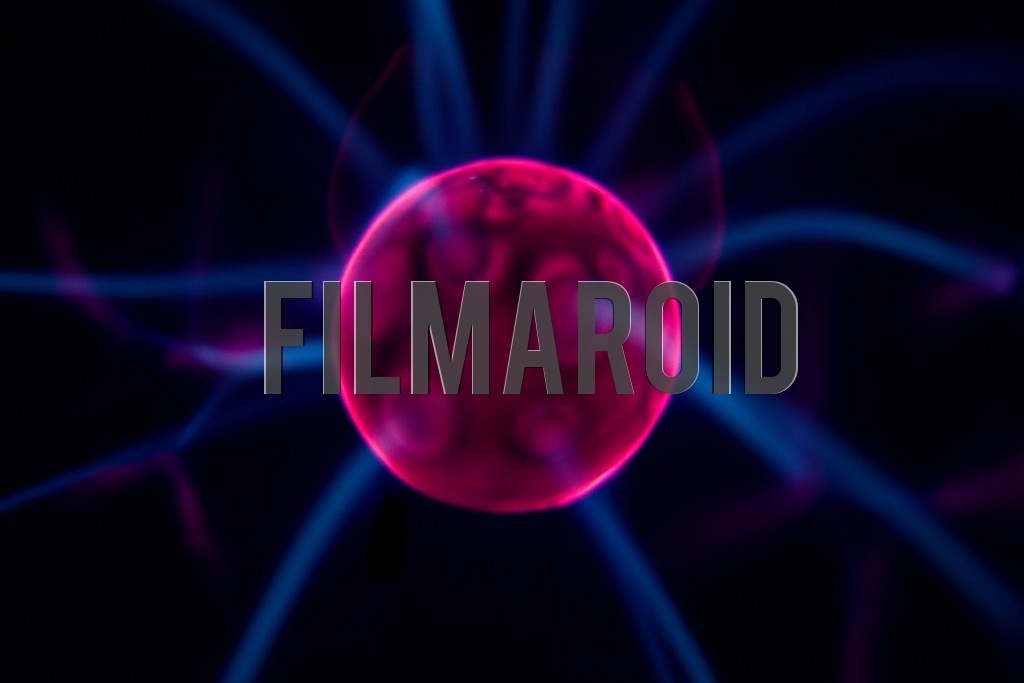 Detail view of bright red Plasma ball center with electric blue rays emitting from it and against pitch black background