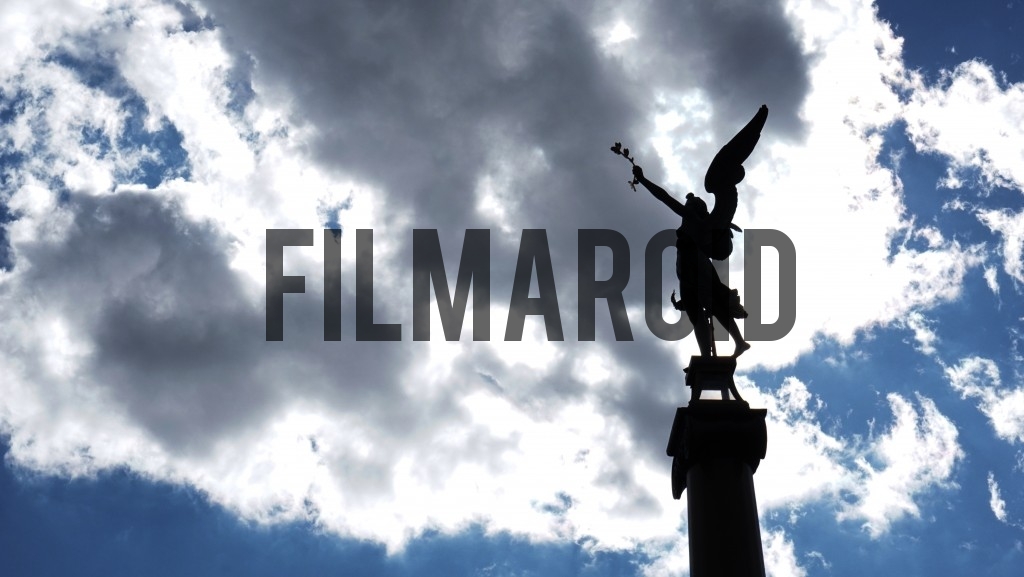 Statue from Prague against a blue cloudy and sunny sky