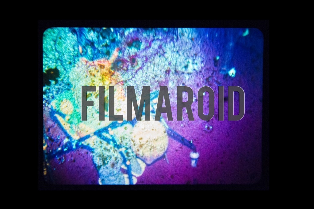 A vintage regular 8mm Kodachrome frame burnt by overheating from projector lamp with lots of dust and grain