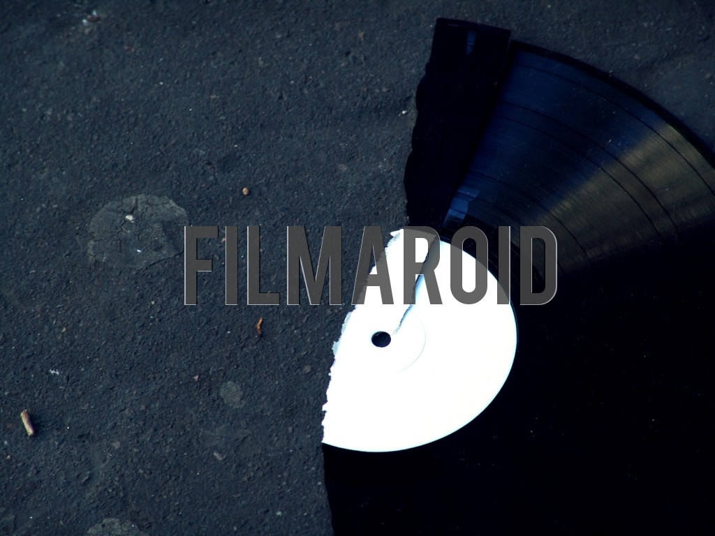 A broken vinyl record lying on street as background