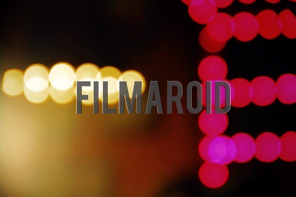 A series of golden and magenta lights creating patterns and viewed out of focus