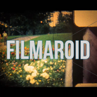 8mm footage of two black men smoking pipe and with sunglasses in the 60s - Vintage 8mm footage of two black men at a park smoking a pipe and wearing stylish 60s clothes