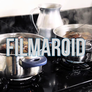 Set of colombian tamales being cooked in boiling water with lots of steam - A couple of Colombian tamales cooking in kitchen pot with boiling water and lots of steam visible