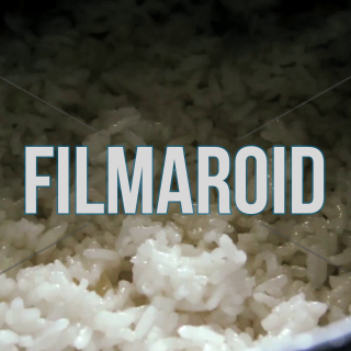 Hand tossing warm and steamy white rice gently with a spoon - A hand tossing warm freshly cooked rice with a spoon