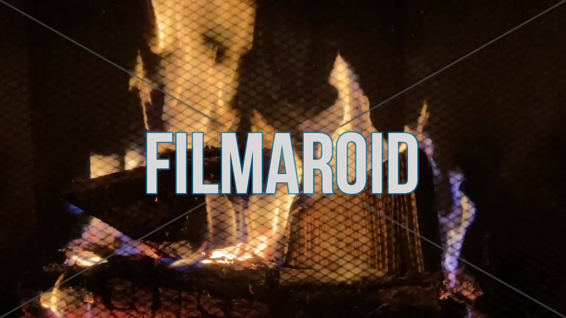 4k still footage of burning wood inside a chimney with protective grid on foreground and large flames with sparks and smoke